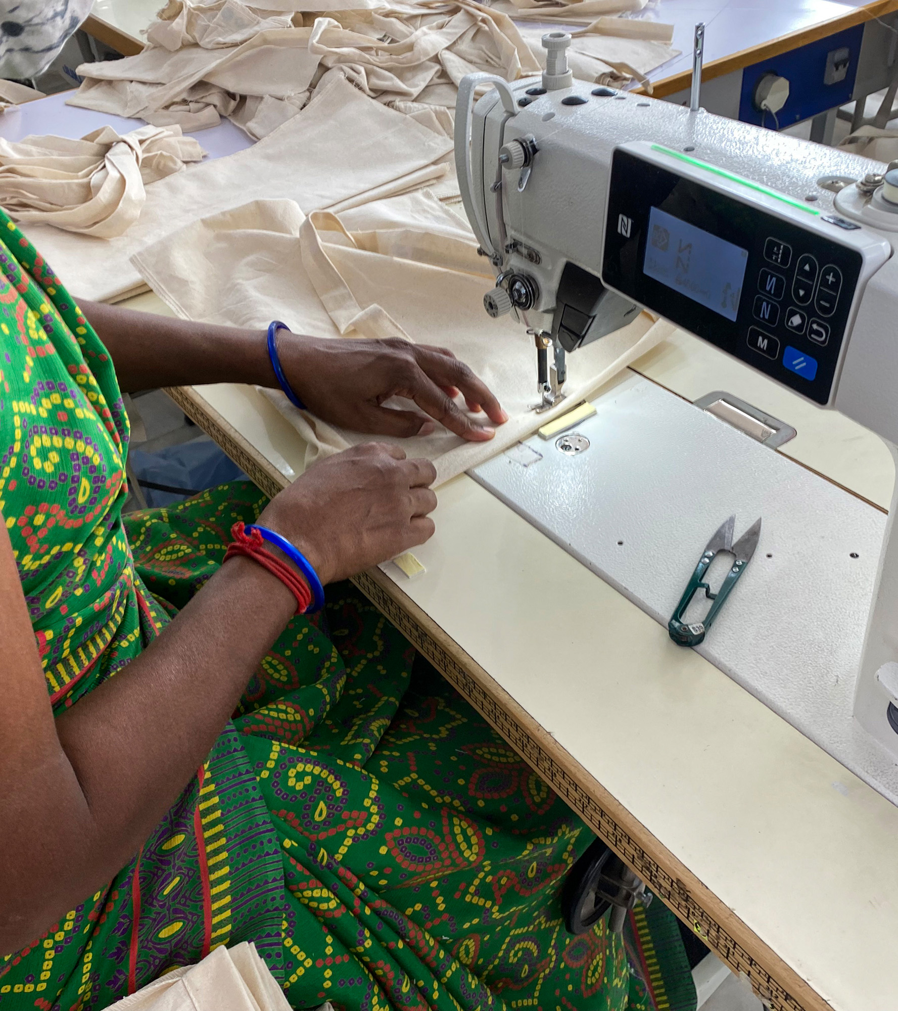 Textile production at a sewing machine in India